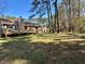 Large backyard with mature trees, a wooden deck, and a detached storage shed at 9364 Woodloop Ct, Jonesboro, GA 30238