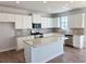 Modern kitchen with white cabinets, granite countertops, stainless steel appliances, and an island at 2664 Mourning Dove Drive( Lot 38), Grayson, GA 30017