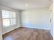 Inviting living room with wood-look floors and a view of the outdoors through a large window at 2664 Mourning Dove Drive( Lot 38), Grayson, GA 30017