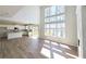 Open-concept living area with soaring ceilings, large windows, and views of the outdoors and adjacent kitchen at 2664 Mourning Dove Drive( Lot 38), Grayson, GA 30017