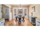 Dining area featuring a bay window, hardwood floors, and a view to the backyard at 321 Oak Cir, Douglasville, GA 30134