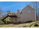 Back exterior of home featuring a wooden deck and a well maintained lawn at 321 Oak Landing Cir, Douglasville, GA 30134