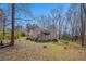 Spacious backyard featuring a deck, lush lawn and plenty of mature trees at 321 Oak Landing Cir, Douglasville, GA 30134