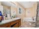 This bathroom features a vanity, soaking tub, toilet, and window at 321 Oak Landing Cir, Douglasville, GA 30134