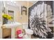 Traditional bathroom features a pedestal sink, toilet, and decorative shower curtain at 321 Oak Landing Cir, Douglasville, GA 30134