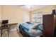 This bedroom features carpet flooring, a ceiling fan, blinds and a personal workstation at 321 Oak Landing Cir, Douglasville, GA 30134