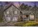 Charming two-story home with a front porch and a two-car garage and tan siding and shutters at 321 Oak Landing Cir, Douglasville, GA 30134