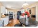 The kitchen features stainless steel appliances, white cabinets, hardwood floors, and a view of the dining area at 321 Oak Landing Cir, Douglasville, GA 30134