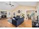 The bright living room with a fireplace flows into the dining area with large windows at 321 Oak Landing Cir, Douglasville, GA 30134