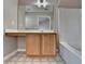 Bathroom with tile flooring, wooden cabinets, and large mirror above the sink at 657 Kenridge Dr, Suwanee, GA 30024