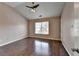 Cozy bedroom featuring wood floors, ample natural light, and a ceiling fan at 657 Kenridge Dr, Suwanee, GA 30024