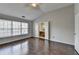 Bedroom with wood flooring, vaulted ceiling, large window, and access to the bathroom at 657 Kenridge Dr, Suwanee, GA 30024
