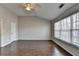 Bright bedroom with a ceiling fan, wood floors, a window, and a view of the ensuite bathroom at 657 Kenridge Dr, Suwanee, GA 30024