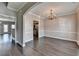 Bright dining room with elegant chandelier and doorway view to the kitchen and living room at 657 Kenridge Dr, Suwanee, GA 30024