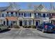 Inviting townhome showcasing brick and siding exterior, private entrances, manicured landscaping, and convenient parking at 657 Kenridge Dr, Suwanee, GA 30024