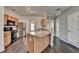A view of the kitchen with stainless steel appliances, light wood cabinets, and an island at 657 Kenridge Dr, Suwanee, GA 30024