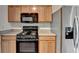 A kitchen equipped with modern black appliances, light-colored cabinets, and stainless steel refrigerator at 657 Kenridge Dr, Suwanee, GA 30024