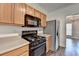 A view of the kitchen with stainless steel appliances and light wood cabinets at 657 Kenridge Dr, Suwanee, GA 30024