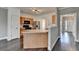 Bright kitchen featuring wooden cabinets, stainless steel refrigerator, kitchen island, and hardwood floors at 657 Kenridge Dr, Suwanee, GA 30024