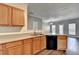 A partial view of the kitchen featuring light wood cabinets, laminate countertops, and hardwood floors at 657 Kenridge Dr, Suwanee, GA 30024