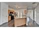 Well-designed kitchen with stainless appliances, hardwood floors, a central island and access to other rooms at 657 Kenridge Dr, Suwanee, GA 30024
