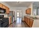 Charming kitchen with stainless steel appliances, wood cabinets, and view to the dining room at 657 Kenridge Dr, Suwanee, GA 30024