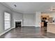 Open floor plan living room with a fireplace, and an adjacent kitchen with wood cabinets at 657 Kenridge Dr, Suwanee, GA 30024