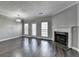 Living room featuring a fireplace, large windows, wood floors, neutral paint, and a decorative ceiling at 657 Kenridge Dr, Suwanee, GA 30024