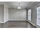Well-lit living room featuring wood floors, large windows, and access to the outdoor space at 657 Kenridge Dr, Suwanee, GA 30024