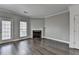 Inviting living room with fireplace, beautiful hardwood floors, a window and access to the exterior of the home at 657 Kenridge Dr, Suwanee, GA 30024