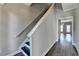 A view of the stairway featuring hard wood floors and neutral-colored walls at 657 Kenridge Dr, Suwanee, GA 30024