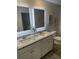 Bright bathroom with double vanity, granite countertop and large, illuminated mirrors at 740 Great Oak Pl, Villa Rica, GA 30180