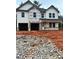 New construction home featuring two-car garage, covered porch, and unfinished landscaping at 740 Great Oak Pl, Villa Rica, GA 30180