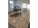 Kitchen with granite countertops, stainless steel sink, and dining area at 740 Great Oak Pl, Villa Rica, GA 30180