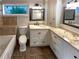 Well-appointed bathroom with a tile floor, custom cabinets, and soaking tub at 121 Northwoods Rd, Sharpsburg, GA 30277