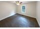 Neutral carpeted bedroom with standard window and ceiling fan at 121 Northwoods Rd, Sharpsburg, GA 30277