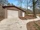 A single-car detached garage is well-maintained and features a side entry door for easy access and convenience at 121 Northwoods Rd, Sharpsburg, GA 30277
