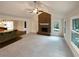 Open living space with brick fireplace, vaulted ceilings, and hardwood floors at 121 Northwoods Rd, Sharpsburg, GA 30277