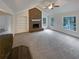 Bright living room featuring a brick fireplace and vaulted ceilings at 121 Northwoods Rd, Sharpsburg, GA 30277