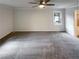 Spacious main bedroom with carpet flooring and bright natural light at 121 Northwoods Rd, Sharpsburg, GA 30277