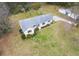 Charming single-story home with a neutral exterior, well-maintained lawn, and outbuildings on a spacious lot at 1312 Milstead Ave, Conyers, GA 30012
