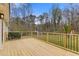 View of the back deck with iron railing overlooking a large, well maintained yard at 1312 Milstead Ave, Conyers, GA 30012