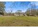 Expansive backyard featuring lush lawn, mature trees and back exterior at 1312 Milstead Ave, Conyers, GA 30012