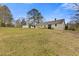 Expansive backyard featuring lush lawn, outbuilding and mature trees at 1312 Milstead Ave, Conyers, GA 30012