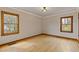 Bedroom features hardwood floors and large windows with natural light at 1312 Milstead Ave, Conyers, GA 30012
