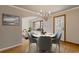 Cozy dining area with modern chandelier and view to front lawn at 1312 Milstead Ave, Conyers, GA 30012