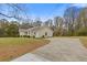 Long driveway leading to the front exterior of the home with a large front yard at 1312 Milstead Ave, Conyers, GA 30012