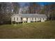 Charming one-story home with mature trees and a spacious front yard at 1312 Milstead Ave, Conyers, GA 30012