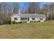 Charming front exterior featuring manicured landscaping and an inviting facade at 1312 Milstead Ave, Conyers, GA 30012