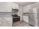 Bright kitchen with white cabinets and stainless steel appliances at 1312 Milstead Ave, Conyers, GA 30012